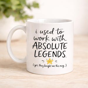 May include: White ceramic mug with black text reading "i used to work with ABSOLUTE LEGENDS". A yellow star graphic is below the text, and the phrase "(yes, they bought me this mug...)" is at the bottom of the mug.