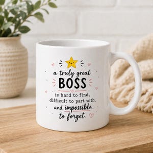 May include: White ceramic mug with a handle, featuring the text "a truly great BOSS" in black, with a yellow star and pink heart accents. The mug also includes the phrases "is hard to find, difficult to part with, and impossible to forget."