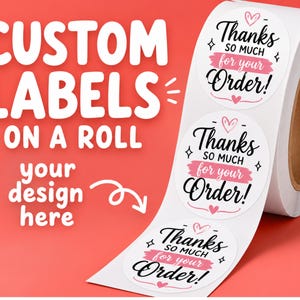May include: A roll of white circular adhesive labels featuring the black and pink text Thanks so much for your Order! with small heart and star accents. The text CUSTOM LABELS ON A ROLL your design here is displayed on a coral background.