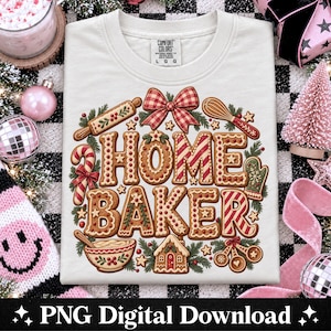 May include: A cream-colored t-shirt featuring a graphic of the text HOME BAKER styled as gingerbread cookies. The design includes a rolling pin, whisk, candy cane, oven mitt, mixing bowl, and measuring spoons, all accented with red and white bows.
