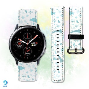 May include: A white watch band with a blue floral pattern. The band is designed for a smartwatch with a round face. The watch face displays the date, time, and temperature. The band has a black leather strap on the back.