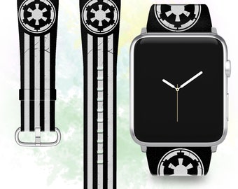 May include: A black and white Apple Watch band with a distressed look and a white Imperial symbol. The band is shown on a silver Apple Watch.