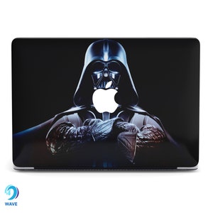 May include: A black laptop with a Darth Vader design on the lid. The Apple logo is visible in the center of the design.