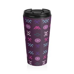 May include: A purple travel mug with a geometric pattern of pink, blue and grey symbols. The mug has a black lid.