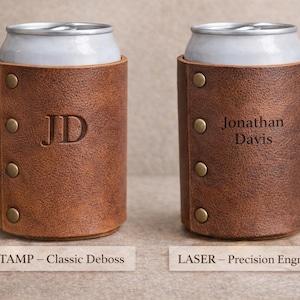 May include: Two brown leather can coolers, each holding a silver can. One cooler has "JD" debossed, the other has "Jonathan Davis" engraved. Both have brass rivets and the text "STAMP - Classic Deboss" and "LASER - Precision Engraving".