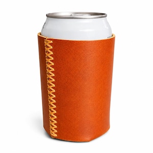 May include: A brown leather can cooler with a white can inside. The cooler has a stitched seam in a lighter shade of brown. The can is silver and white. The cooler is designed to keep beverages cold.