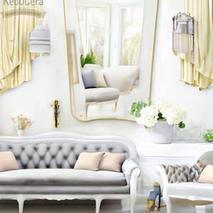 May include: A white, tufted sofa with a curved back and four legs. The sofa has two light pink pillows and is in a room with a large, gold-framed mirror and white walls.