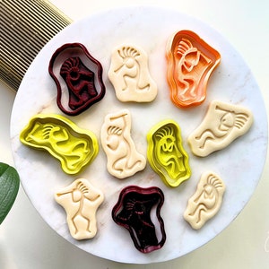 May include: A set of nine cookie cutters in various colors, featuring a stylized Native American design. The cutters are made of plastic and are perfect for making cookies or fondant decorations.