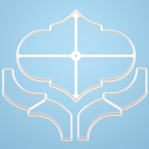 May include: A white, ornate cookie cutter with a symmetrical design. The cutter features a central oval shape intersected by a cross, with curved, stylized elements extending below. The background is a light blue.