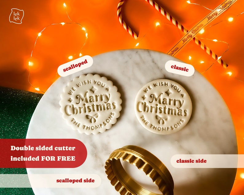May include: A double-sided cookie cutter with a scalloped and classic design. The cutter is made of gold metal and features the text "We wish you a Merry Christmas The Thompsons".