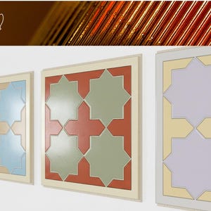 May include: Three framed wall art pieces with geometric star patterns in various colors. The frames are light beige, and the star patterns include blue, beige, red, green, and yellow. The artwork is displayed on a white wall.