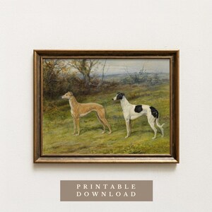 May include: A framed vintage painting depicts two greyhounds in a grassy field. One is tan, the other white with black spots. The background shows trees and a cloudy sky. The frame is a dark wood color. Text at the bottom reads "PRINTABLE DOWNLOAD".