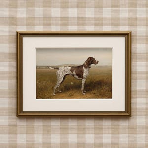 May include: Framed artwork featuring a brown and white dog in a field. The dog is a pointer breed, standing in a grassy area with a distant landscape. The artwork is in a gold-colored frame, adding a classic touch to the piece.