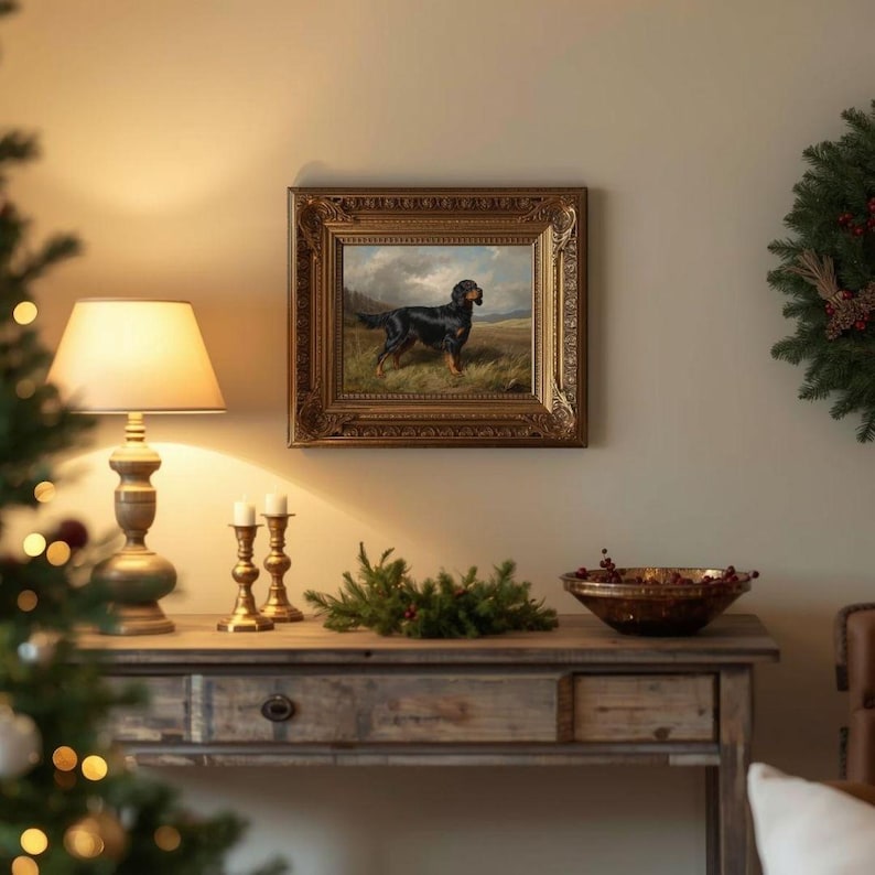May include: An antique oil painting of a black dog in a field, framed in ornate gold. The painting hangs above a wooden console table with a lamp, candles, and a decorative bowl. A Christmas wreath is on the wall.