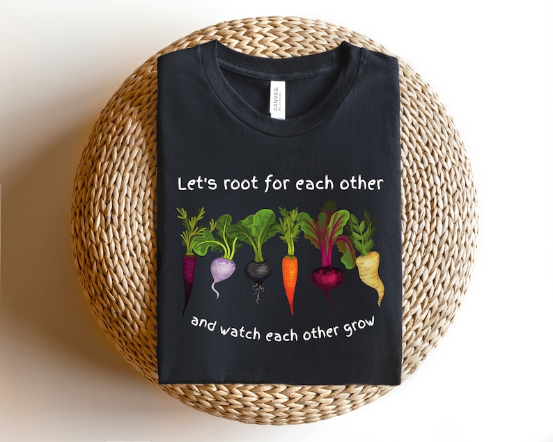 May include: Black t-shirt with a white graphic of five colorful vegetables with the text "Let's root for each other and watch each other grow".