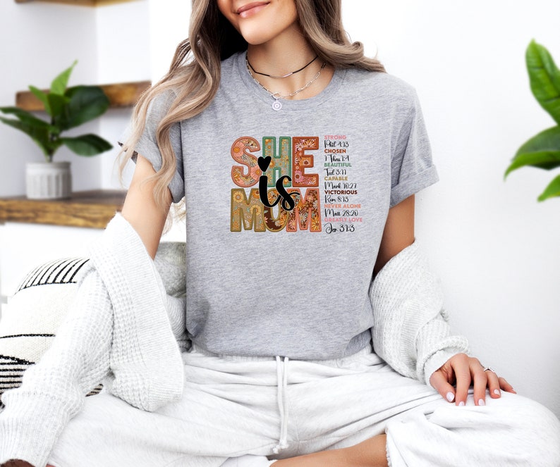 May include: Grey t-shirt with a floral design and the text "SHE is MOM" with bible verses.