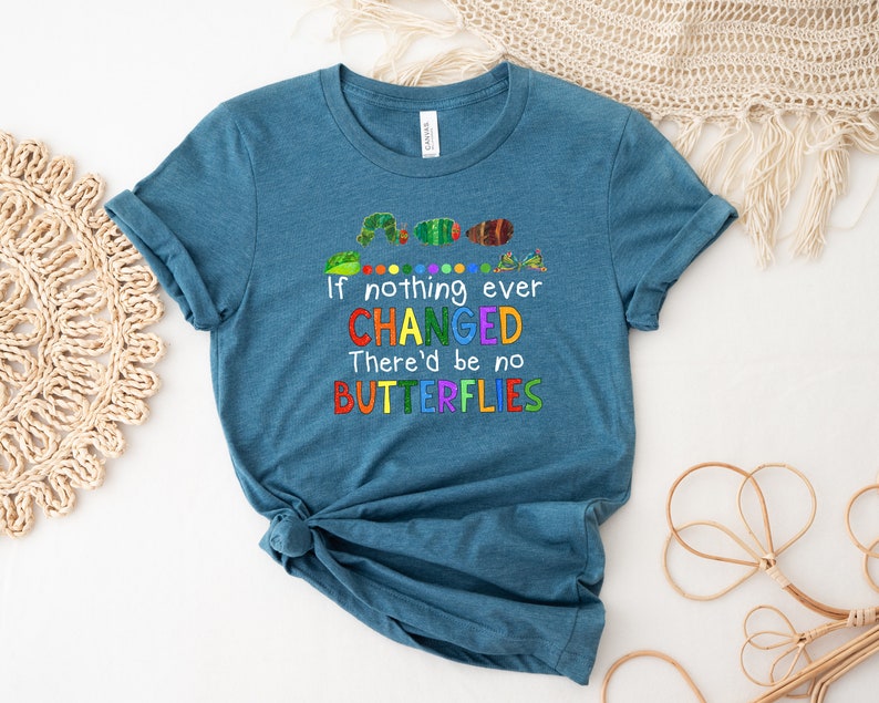 May include: Teal blue t-shirt with a colorful caterpillar graphic and the text "If nothing ever CHANGED There'd be no BUTTERFLIES".