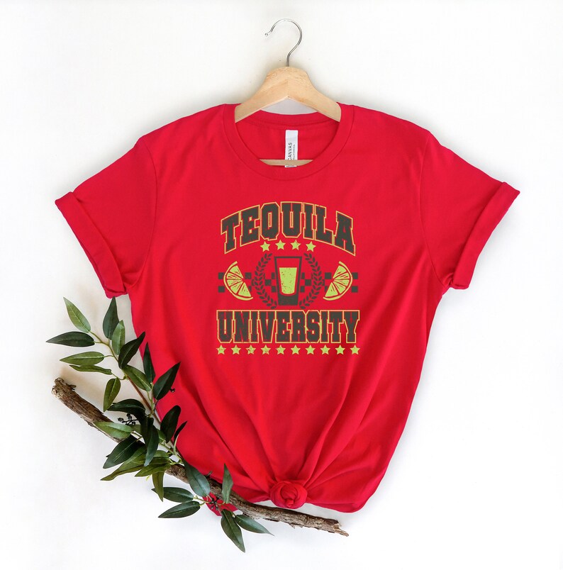 May include: Red t-shirt with a graphic design that says "Tequila University" with a shot glass and lime wedges.