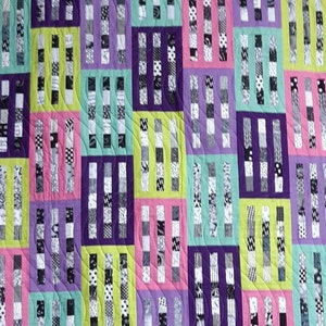May include: A quilt with a geometric pattern of black and white stripes on a purple, green, pink, and yellow background.