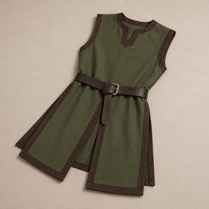 May include: A sleeveless olive green tunic featuring a dark brown trim along the neckline, armholes, and hem. The garment includes a front slit and a dark brown leather-like belt with a metal buckle cinched around the waist area.