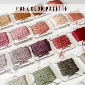 May include: A collection of embroidery floss spools in various colors, including beige, pink, red, purple, green, and brown. The spools are arranged in rows on a white surface. The text "PDF COLOR PALETTE" is at the top of the image.