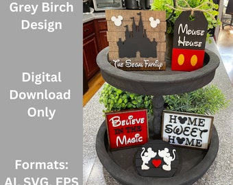 May include: A two-tiered wooden tray with a black finish. The top tier has a sign that says "Mouse House" with Mickey Mouse ears and red circles. The bottom tier has a sign that says "Believe in the Magic", a sign that says "Home Sweet Home", and a Mickey Mouse couple silhouette.