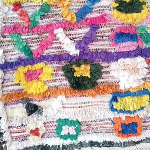 Handmade Moroccan Boucharouite rug with colorful geometric patterns, made from recycled fabric.