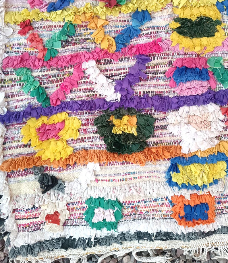 Handmade Moroccan Boucharouite rug with colorful geometric patterns, made from recycled fabric.