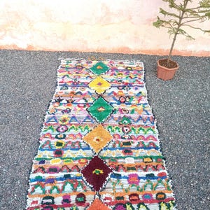 Handmade Moroccan Boucharouite rug with colorful geometric patterns, made from recycled fabric.