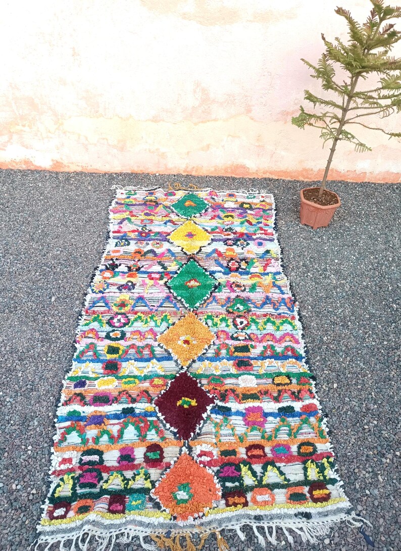 Handmade Moroccan Boucharouite rug with colorful geometric patterns, made from recycled fabric.
