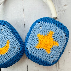 May include: A pair of blue and yellow crocheted headphone covers with a star design. The covers are made of soft yarn and are perfect for protecting your headphones from scratches and dirt.