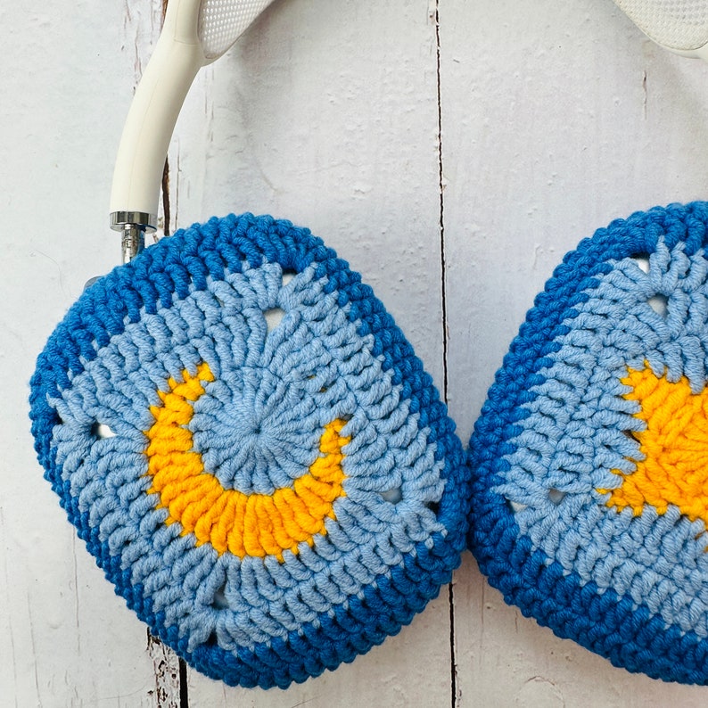 May include: Blue and yellow crocheted headphone covers with a crescent moon design.