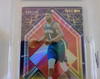 May include: A graded sports card featuring Zion Williamson of the New Orleans Pelicans. The card is a 2021 Recon Holo Red, numbered 98/199 and 098/199. The card is graded a 9 by GMA.