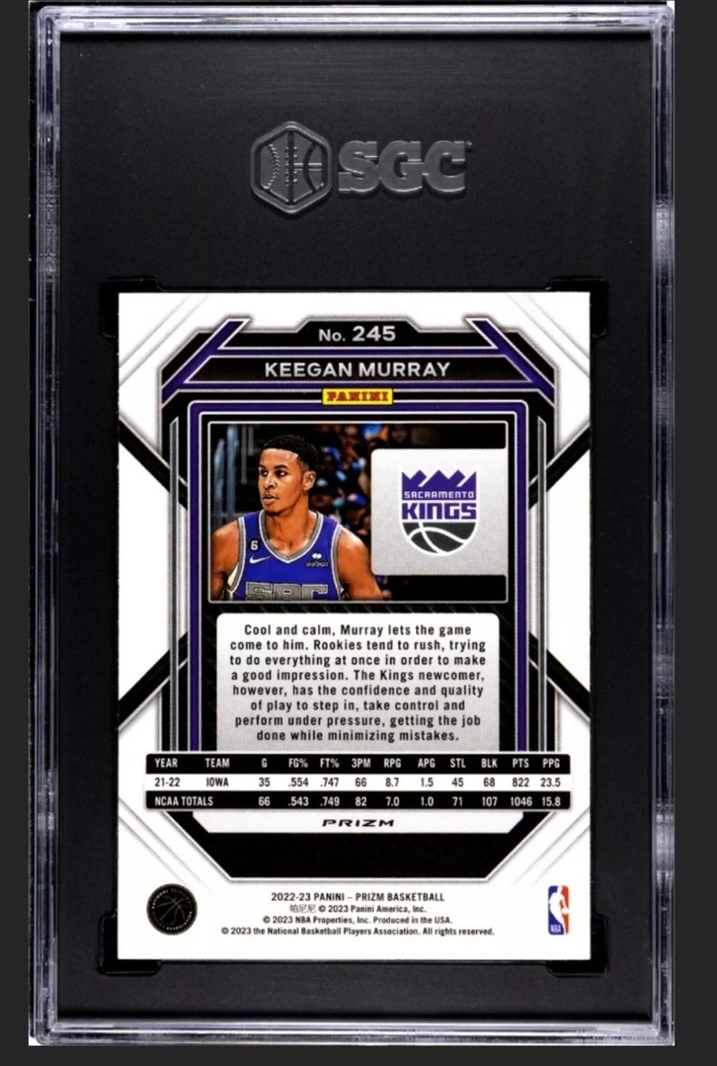 May include: A basketball trading card featuring Keegan Murray, a player for the Sacramento Kings. The card is a Prizm card from the 2022-23 Panini Prizm Basketball set. The card features a photo of Murray in his Kings uniform, along with his stats and a brief description of his playing style.
