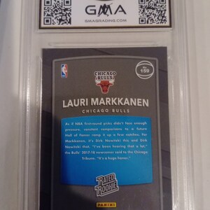 May include: A blue and white basketball card featuring Lauri Markkanen, a player for the Chicago Bulls. The card is from the 2017-18 Panini Donruss Optic Basketball series and has a Rated Rookie designation. The card number is 159.
