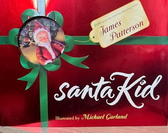 May include: A red book with a green bow and a gold tag that says "from the #1 New York Times Bestselling Author James Patterson" and the title "Santa Kid" in gold lettering. The book is illustrated by Michael Garland.