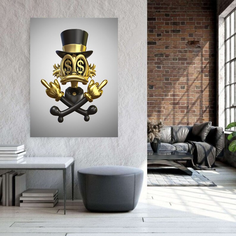 May include: A gold cartoon duck wearing a top hat with dollar signs for eyes, giving the middle finger with both hands, and a skull and crossbones behind it.