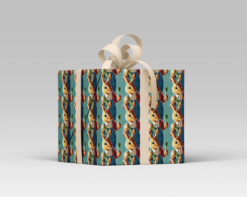 May include: A wrapped gift box featuring a repeating pattern of a rabbit holding a carrot, dressed in a waistcoat and jacket. The background is teal. The box is tied with a cream-colored ribbon and bow.
