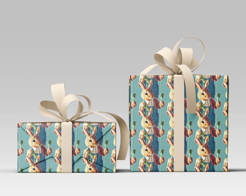 May include: Two wrapped gift boxes with cream-colored ribbon bows. The boxes are covered in wrapping paper featuring a repeating pattern of a rabbit in a red jacket and blue overalls holding a carrot on a teal background. The bows are tied around the boxes.