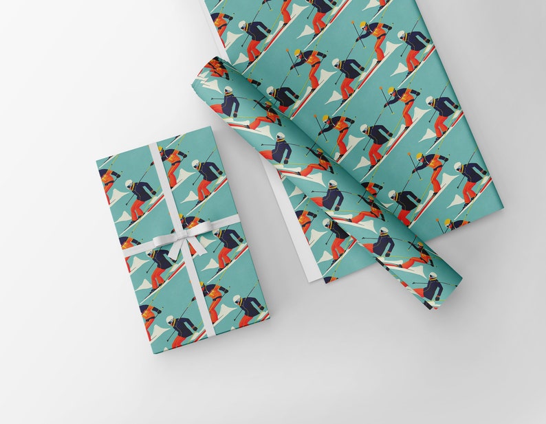 May include: Gift wrap featuring a repeating pattern of skiers in action on a teal background. The skiers are depicted in a retro style, wearing orange, black, and white outfits. A wrapped gift with a white ribbon is also visible.
