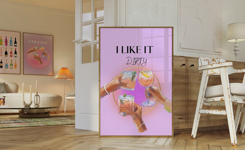 May include: A pink poster with the text "I LIKE IT Dirty" in black lettering. Three hands are holding up glasses of cocktails with a gold circle around them.