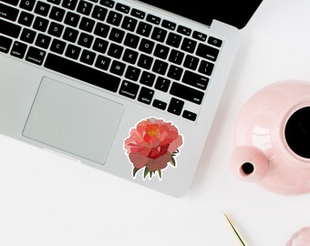 May include: A pink peony flower sticker on a silver laptop computer.
