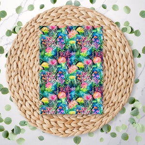 May include: A colorful fabric with a repeating pattern of pink, yellow, and blue flowers and coral on a dark blue background.
