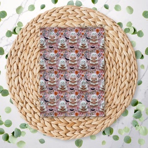 May include: A patterned Halloween-themed design featuring repeating illustrations of ghosts reading books. The ghosts are white with tan book covers, set against a pink background with orange flowers, bats, and pumpkins. The design is on a clear, square surface.