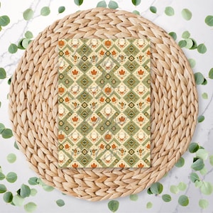 May include: A rectangular card featuring a repeating diamond pattern in shades of cream, sage green, and orange. The design includes small illustrations of pumpkins, maple leaves, acorns, and ghosts arranged within the geometric grid layout.