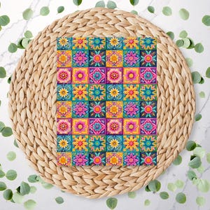 May include: A vibrant square pattern with floral designs arranged in a grid. The squares showcase flowers in pink, yellow, and blue, set against a dark teal background. The pattern is placed on a woven, circular placemat.