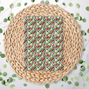 May include: A blue background with a repeating pattern of red strawberries and white flowers. The pattern is ideal for crafting projects, scrapbooking, and other DIY projects.