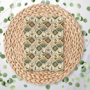 May include: A patterned fabric with a repeating design of deer, trees, mountains, and geometric shapes in green, brown, and beige. The fabric is placed on a woven, circular placemat, with scattered green leaves around the edges.