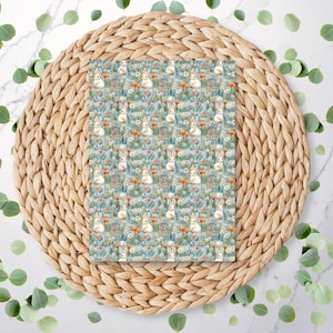 May include: A seamless pattern featuring white bunnies in a field of blue and green flowers. The bunnies are surrounded by orange and yellow flowers. The pattern is perfect for fabric, wallpaper, or wrapping paper.