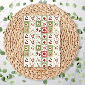 May include: A rectangular card featuring a repeating grid pattern of small squares. The design includes illustrations of white chickens, red strawberries, red cherries, and pink roses on backgrounds of green, white, and red checkered patterns.
